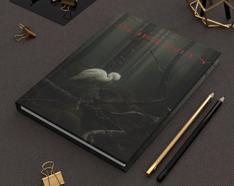 Titled Serenity, with an art cover of a white bird in contrast to a dark, misty forest. Hardcover Journal Matte