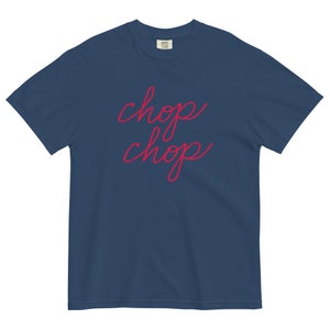 May include: A navy blue t-shirt with the words "chop chop" written in red cursive.