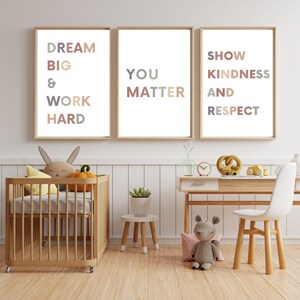 May include: Three framed prints with motivational quotes in a nursery setting. The prints feature the text "Dream Big & Work Hard", "You Matter", and "Show Kindness and Respect".