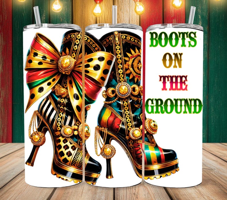 May include: A white tumbler with a colorful illustration of a high-heeled boot with a large bow. The text "BOOTS ON THE GROUND" is printed on the tumbler.