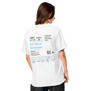 May include: White t-shirt with the text "Full Stack Developer" in blue and black. The shirt also features a graphic with the text "100% DEBUG POWER JS" and other text and icons. The person is facing away from the camera.