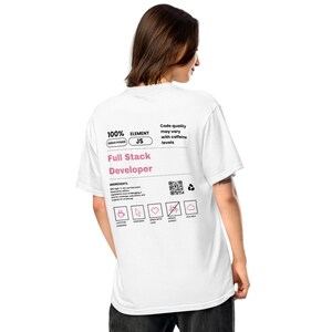 May include: White t-shirt with the text "Full Stack Developer" in pink. The shirt also features the text "100% DEBUG POWER JS" and icons representing ingredients. The back of the shirt is visible.