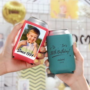 May include: Two red and teal can coolers. The red cooler has a photo of a young boy with the text "Since 1994". The teal cooler has the text "Jen's 30th Birthday!" with a party hat graphic and "miami 11.22.24".