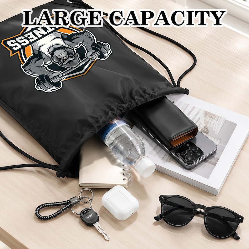 May include: A black drawstring backpack featuring a graphic of a gorilla lifting a barbell with the text LARGE CAPACITY. The bag contains a clear water bottle, a black wallet, a smartphone, a notebook, white earbuds, a key, and black sunglasses.
