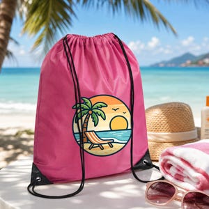 May include: A bright pink drawstring bag featuring a circular graphic of a beach scene with a palm tree, a lounge chair, and a setting sun. The bag has black cord straps and is constructed from a smooth, lightweight fabric material.