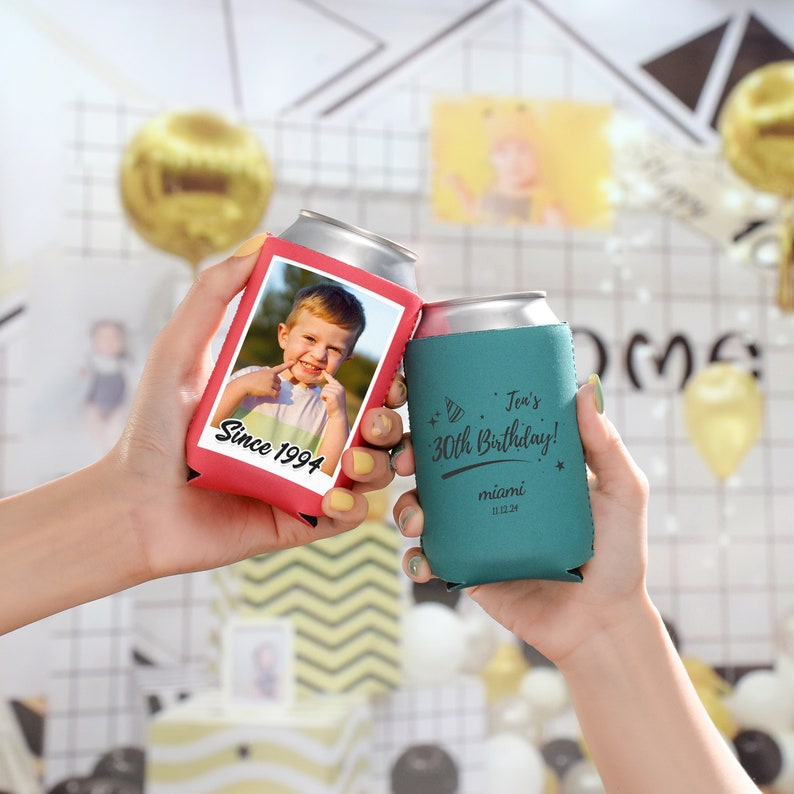 May include: Two red and teal can coolers. The red cooler has a photo of a young boy with the text "Since 1994". The teal cooler has the text "Jen's 30th Birthday!" with a party hat graphic and "miami 11.22.24".