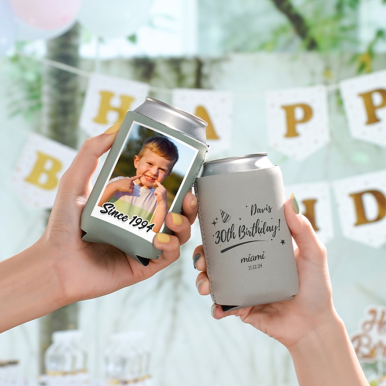 May include: Two gray can coolers. One cooler has a photo of a young boy with the text "Since 1994". The other cooler has the text "Davis 30th Birthday! Miami 11.12.24".