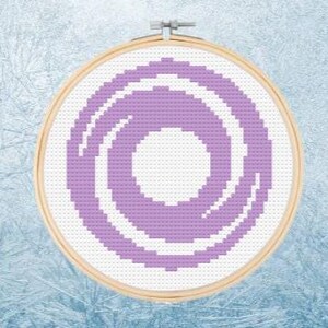 May include: An embroidery hoop with a swirling design in shades of purple and white. The design is a series of concentric circles.