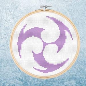 May include: A purple abstract design embroidered on white fabric in a circular embroidery hoop.