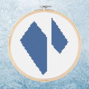 May include: A blue cross stitch pattern of two diamond shapes in a wooden embroidery hoop.