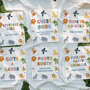 May include: Six party signs with a jungle animal theme. Each sign features colorful illustrations of a lion, zebra, elephant, monkey, bird, and alligator. Text on the signs includes "Editable Sign", "Guest Book", "Time to Go Wild", "Gifts + Cards", "Photo Booth", and "Fuel for Party Animals".