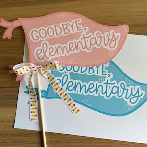 May include: Two blue and pink paper signs with the text "Goodbye, Elementary" on them. The signs are attached to a wooden stick with a yellow and white ribbon tied around it.