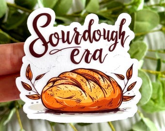 May include: White sticker with brown text that reads "Sourdough era" and a cartoon illustration of a loaf of sourdough bread.