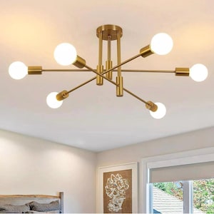 May include: A contemporary gold ceiling light with six spherical bulbs. The fixture has a central mounting plate and radiating arms. The bulbs are evenly spaced, creating a starburst effect. The light is bright and illuminates the room.