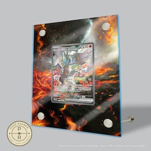 Könnte beinhalten: Eine gerahmte Pokémon-Sammelkarte mit Reshiram EX vor einem feurigen Hintergrund. Die Karte wird in einem transparenten Acrylrahmen mit silberner Hardware präsentiert. Der Rahmen hat einen blauen Rand und ein rundes Logo unten links.