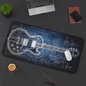 May include: A blue and white guitar blueprint design on a black mouse pad. The guitar is a Les Paul style electric guitar with a white outline.