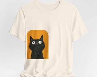 May include: A white t-shirt with a black cat illustration on the front. The cat is looking up with big eyes and is surrounded by a yellow rectangle.
