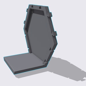 May include: A gray hexagonal box with a hinged lid. The lid is open and the box is sitting on a flat surface.