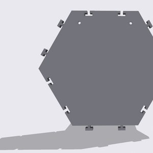May include: A gray hexagonal tile with interlocking edges. The tile has a smooth surface and is designed to be connected to other tiles.