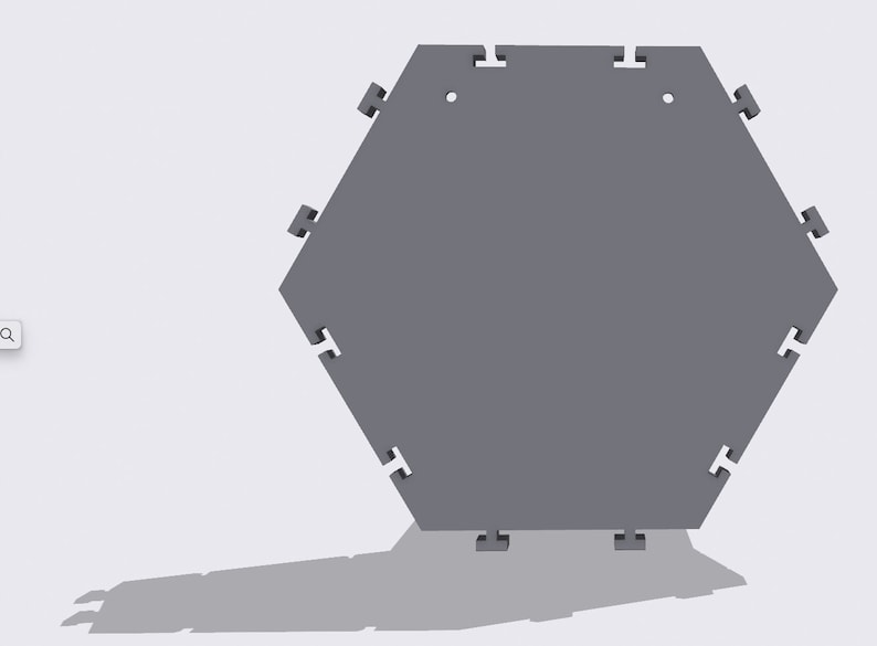 May include: A gray hexagonal tile with interlocking edges. The tile has a smooth surface and is designed to be connected to other tiles.