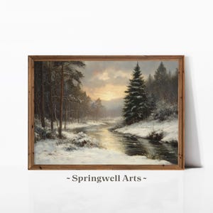 Peut inclure: Peinture de paysage encadrée représentant une scène hivernale enneigée avec une rivière traversant une forêt. L'œuvre présente un coucher de soleil chaleureux et le texte "- Springwell Arts -" en bas.