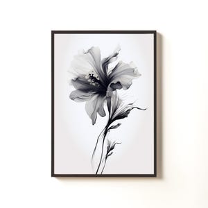 May include: Black and white floral art print in a dark brown frame. The artwork features a detailed illustration of a flower with delicate petals and stems. The grayscale color palette adds a touch of elegance to the botanical theme.