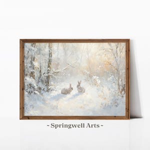 May include: A painting depicting a snowy woodland scene with two rabbits in the foreground. The rabbits are white with brown markings and are standing in the snow. The woodland is covered in snow and the trees are bare. The sky is a light blue colour and there is a faint glow of sunlight in the distance.