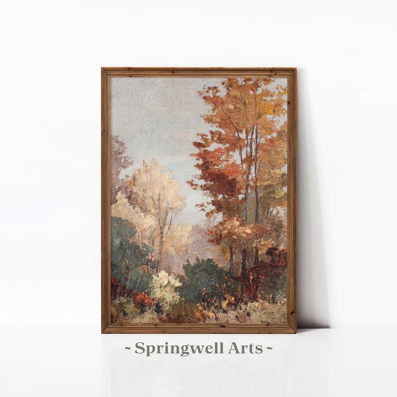 May include: A framed landscape painting featuring a forest scene with trees in autumn colors. The artwork displays a palette of warm hues, including shades of orange, red, and yellow, with a touch of green. The text "- Springwell Arts -" is at the bottom.