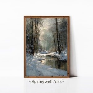 May include: A framed wall art print featuring a winter forest landscape with snow-covered trees and a reflective stream flowing through the centre. The scene is rendered in cool tones of white, grey, and brown. The text Springwell Arts is visible.