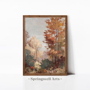 Könnte beinhalten: Gerahmtes Landschaftsgemälde mit einer herbstlichen Waldszene. Das Kunstwerk zeigt Bäume in leuchtenden Herbstfarben, darunter Orange, Rot und Gelb, mit etwas Grün. Der Text "- Springwell Arts -" befindet sich unten.