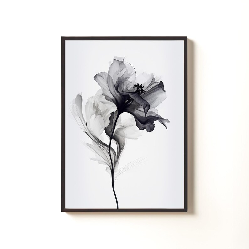 May include: A framed art print featuring a stylized black and white floral design. The artwork showcases a detailed depiction of a flower with delicate petals and a slender stem, set against a white background. The frame is dark, enhancing the contrast.