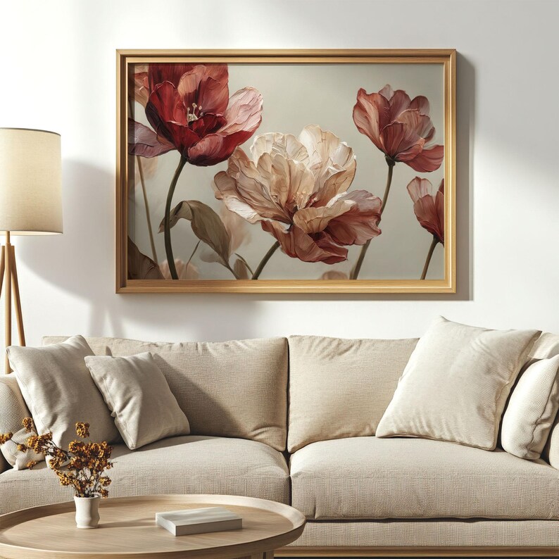 May include: A framed floral art print featuring watercolor-style flowers in shades of red, pink, and cream. The flowers have delicate petals and are set against a neutral background. The frame is a light wood color.