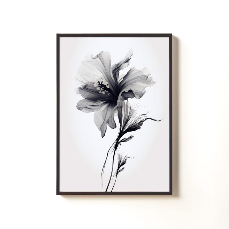 May include: Black and white floral art print in a dark brown frame. The artwork features a detailed illustration of a flower with delicate petals and stems. The grayscale color palette adds a touch of elegance to the botanical theme.