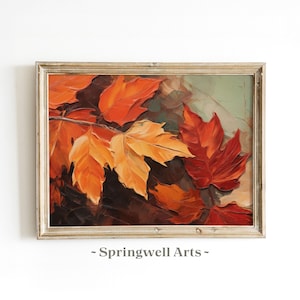 Puede incluir: Pintura enmarcada con temática otoñal que presenta vibrantes hojas de arce naranjas y rojas. La obra de arte tiene un estilo texturizado e impresionista, con un marco dorado. El texto "- Springwell Arts -" está en la parte inferior de la imagen.
