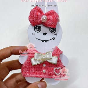 May include: A pink tweed dress for a 4.13-inch doll, featuring a bow and pearl accents. The text reads "TWEED DRESS for mini 4.13" doll" and "CLOTHES ONLY/ DOLL NOT INDCLUDED". Designed by PeachCottonStu.