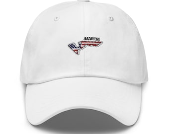 May include: White baseball cap with an embroidered American flag design of the Circuit of the Americas racetrack in Austin, Texas. The text "Austin" is embroidered above the track.