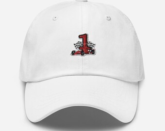 May include: White baseball cap with a red and black embroidered number 1 and checkered flag design. The cap has a curved brim and an adjustable strap at the back. A sporty accessory for fans of racing.