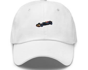 May include: White baseball cap with an embroidered image of a black race car with red and yellow accents.