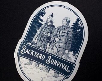 May include: A white oval sticker with a blue illustration of two people hiking in a forest. The text "Backyard Survival" is written in a blue script font on a banner.