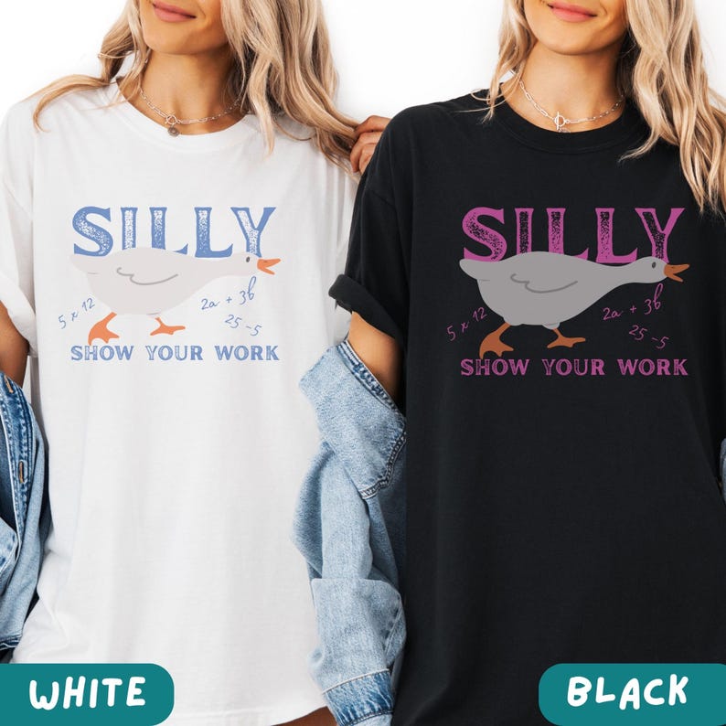 May include: White and black t-shirts with the word "SILLY" above a cartoon goose illustration. The goose has math equations around it, and the phrase "SHOW YOUR WORK" is below. The bottom of the shirts have the words "WHITE" and "BLACK".