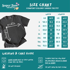 May include: A dark gray unisex t-shirt with a size chart and washing instructions. The size chart includes measurements in inches and centimeters for width and length. Washing instructions include washing in cold water and tumble drying on low heat.