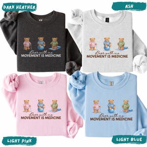 May include: Four sweatshirts in dark heather, ash, light pink, and light blue. Each features a graphic of three teddy bears in different poses with the text "Bear with me, Movement is Medicine".