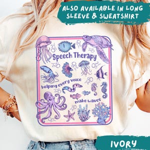 May include: Ivory t-shirt with a colourful graphic of sea creatures and the words "Speech Therapy," "helping every voice," and "make waves." Also available in long sleeve and sweatshirt styles.