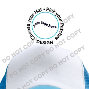 May include: A white and blue trucker hat with a mesh back. The front of the hat has a white circle with the text "Choose your Hat. Pick your Patches" and "your logo here" in black text. The text "DESIGN" is below the circle.