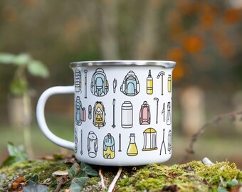 May include: White enamel camping mug with a colorful pattern of camping gear, including backpacks, tents, and hiking sticks.