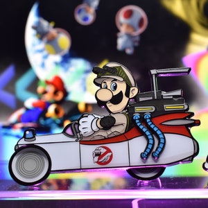 May include: A white and red cartoon car with a ghostbusters logo on the side. A cartoon character wearing a green hat and a mustache is driving the car. The car is on a purple and pink surface.