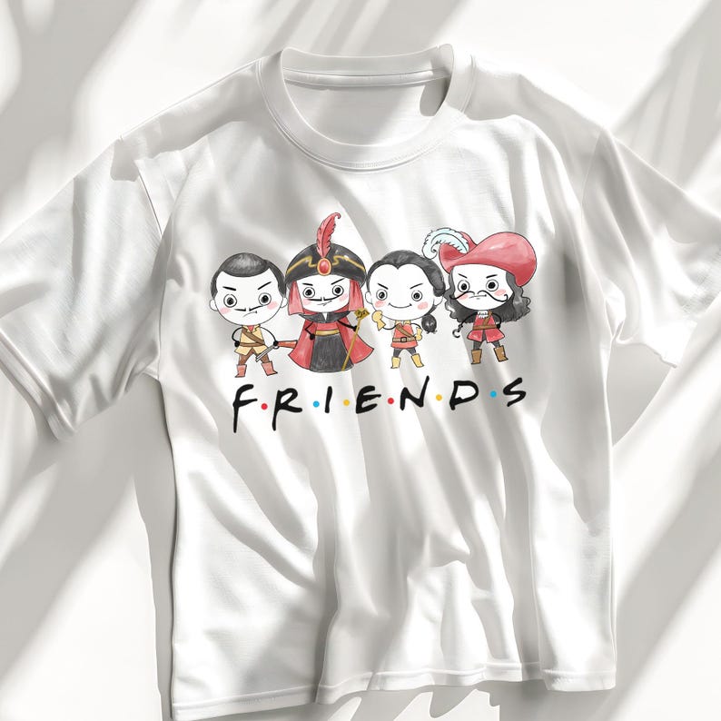 May include: White t-shirt featuring a cartoon graphic of four characters in costume, with the word "FRIENDS" in the style of the TV show logo. The characters are in a line, each with a unique outfit and expression.