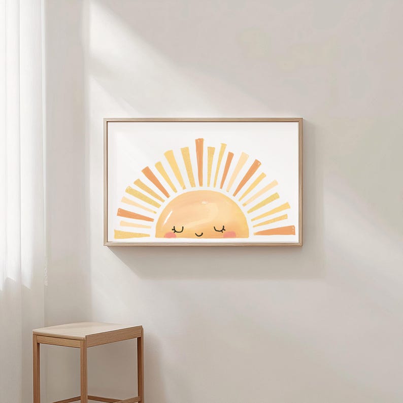 May include: A framed art print featuring a smiling sun design. The sun is depicted in shades of yellow and orange, with a light peach face and a happy expression. The artwork is framed in a light wood frame.