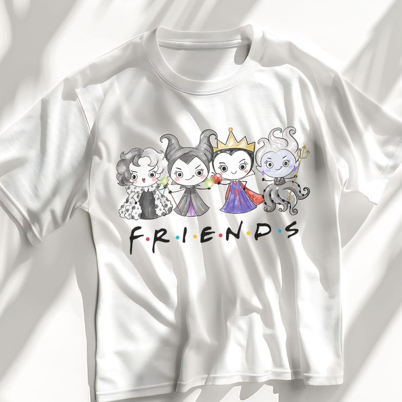 May include: White t-shirt featuring a cartoon graphic of four Disney villains in a Friends-themed design. The villains are Cruella de Vil, Maleficent, the Evil Queen, and Ursula. The word "FRIENDS" is written in the iconic font.
