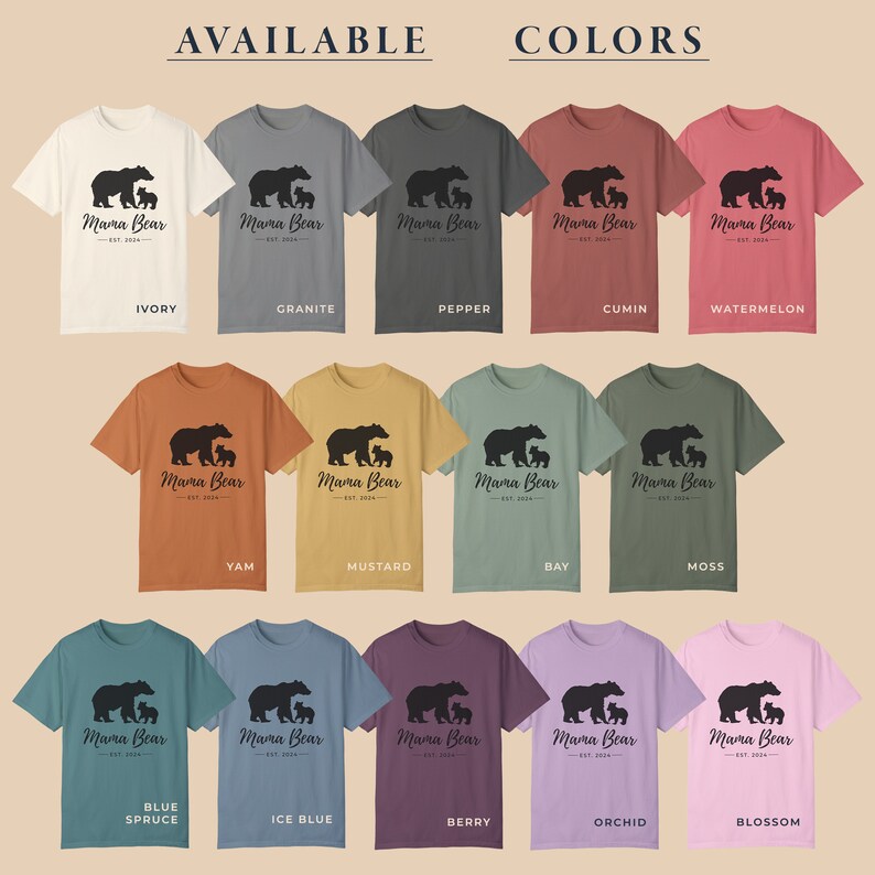 A chart of 15 different t-shirt colors with the words 'Available Colors' at the top. Each color has a t-shirt with a black graphic of a mama bear and two cubs with the text 'Mama Bear Est. 2024' below the graphic. The colors are: Ivory, Granite, Pepper, Cumin, Watermelon, Yam, Mustard, Bay, Moss, Blue Spruce, Ice Blue, Berry, Orchid, and Blossom.